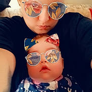 Harper is registered to the contest to win money with this photo: adult, baby, black_shirt, cat_ears, closeup, cozy, cute, face, family, filter, floral_pattern, indoor, lip_piercing, onesie, person, portrait, selfie, stars, sunglasses, unicorn
