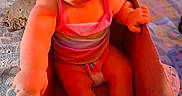 Harper joined the competition — help win amazing prizes! baby, cardboard_box, carpet, child, colorful, curious, cute, diaper_box, expression, floor, home, indoor, infant, person, pink_clothing, playful, reaching, sitting, toy, young