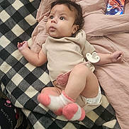 Aurora joined the competition — help win amazing prizes! baby, infant, blanket, pacifier, socks, clothing, bed, sheet, phone, technology, pattern, plaid, cute, lying_down, indoors, child, person, portrait, soft_texture, relaxed