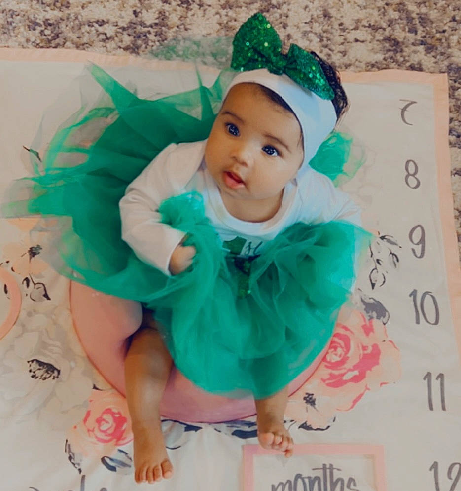 Aleigha joined the competition — help win amazing prizes! aqua, baby, baby_toddler_clothing, cap, child, costume_hat, dress, green, hair_accessory, happy, headband, headpiece, headwear, mythical_creature, pattern, person, picture_frame, pink, product, sleeve
