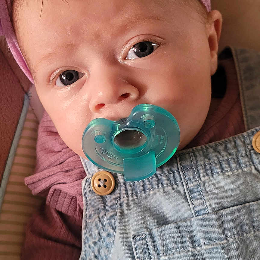 Paislee is registered to the contest to win money with this photo: baby, bodypart, bonnet, can, cap, clothing, couch, face, finger, furniture, hand, hat, head, knitwear, pants, person, photography, portrait, sweater, tin