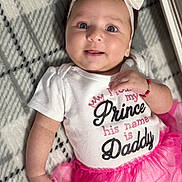 Valery is registered to the contest to win money with this photo: baby, infant, headband, bow, white_clothing, pink_tutu, smiling, face, arm, hand, blanket, patterned_blanket, cute, child, portrait, indoor, happy, young_child, person, fashion