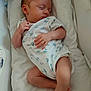 Tiago participe au concours pour gagner de l'argent avec cette photo : baby, child, clothing, cushion, cute, face, foot, hand, head, indoors, infant, lying_down, newborn, onesie, peaceful, person, resting, skin, sleeping, soft