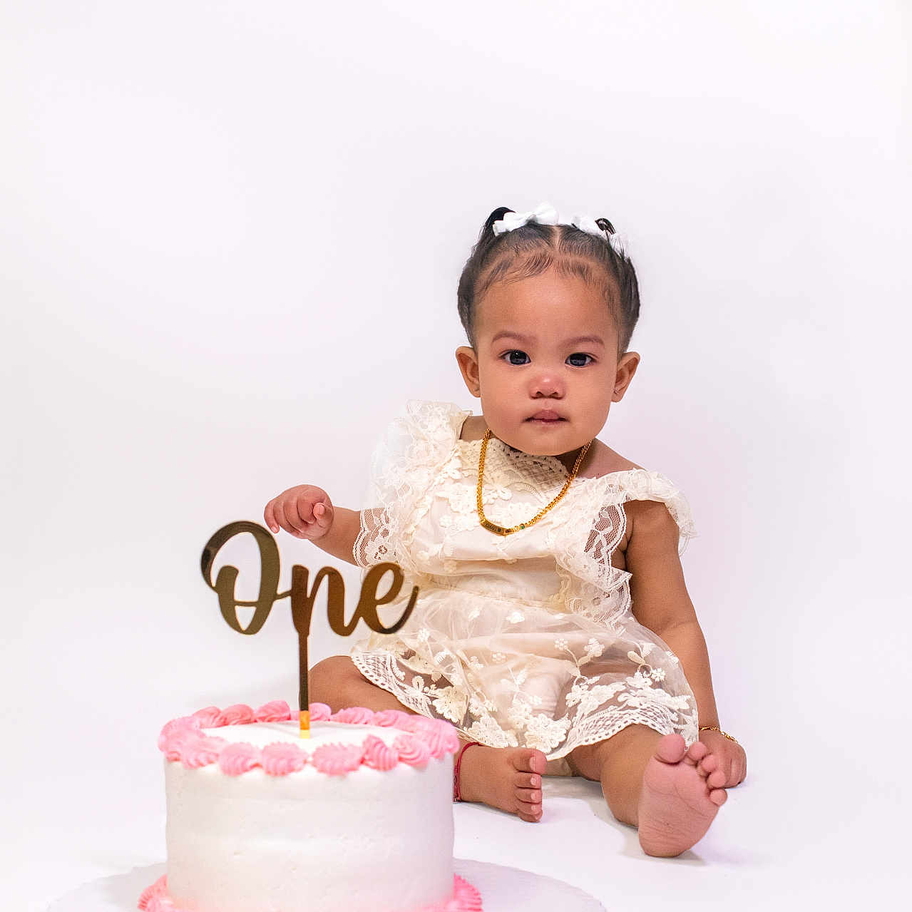 Khaari joined the competition — help win amazing prizes! baby, birthday, bracelet, cake, celebration, child, cute, dress, foot, lace, necklace, one_year_old, party, pink_frosting, portrait, sitting, smile, studio_photo, white_background, young