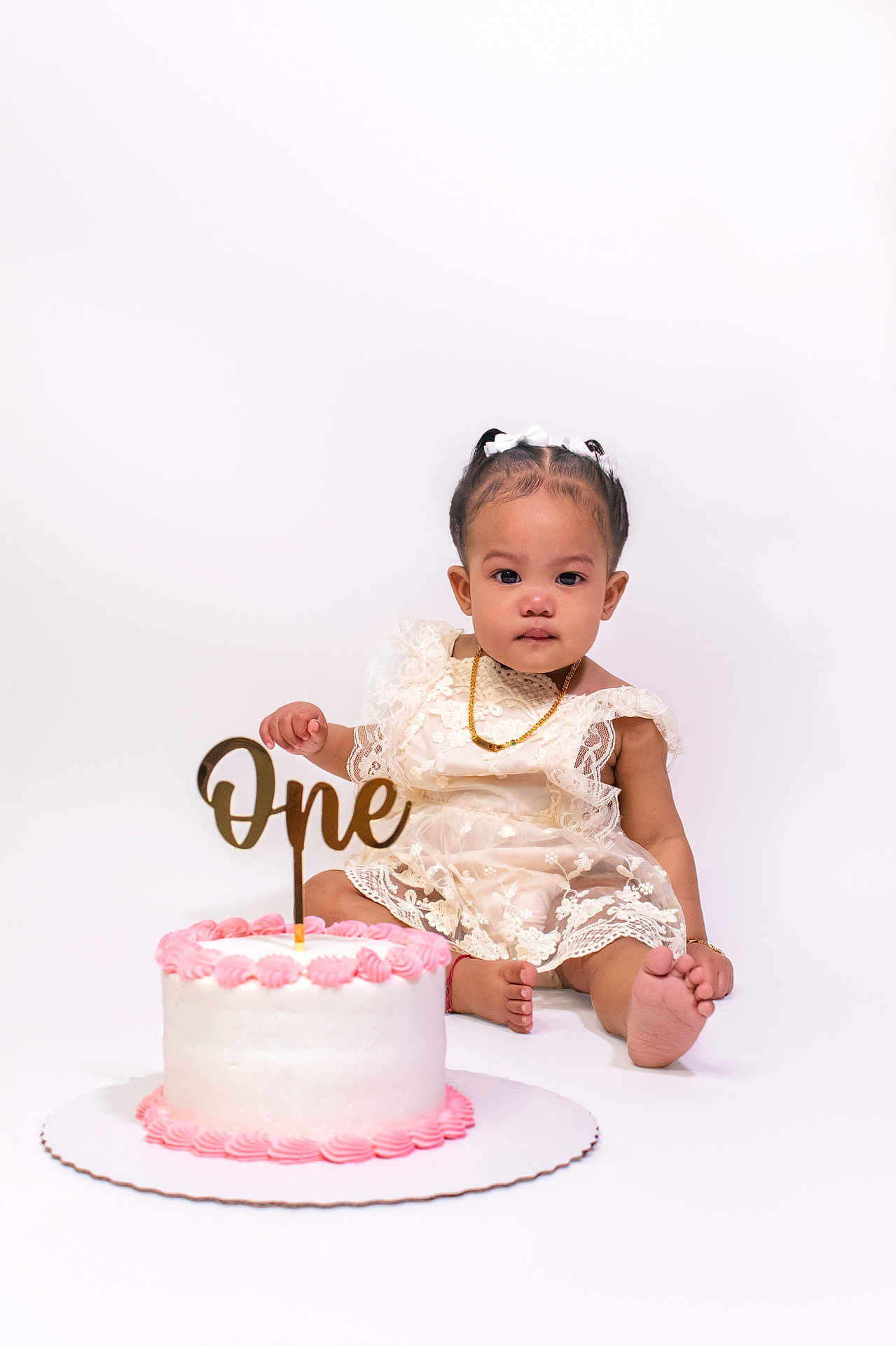 Khaari joined the competition — help win amazing prizes! baby, child, birthday, cake, one_year_old, white_background, dress, lace, pink_frosting, celebration, sitting, foot, necklace, bracelet, cute, portrait, studio_photo, smile, young, party
