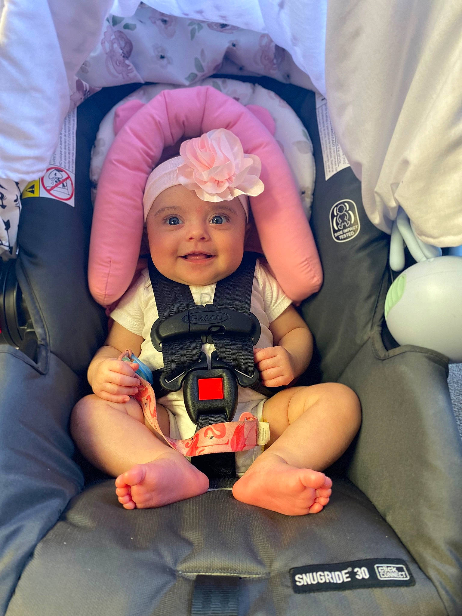 Carmen is registered to the contest to win money with this photo: auto_part, baby, baby_carriage, baby_products, baby_safety, car_seat, child, comfort, finger, fun, happy, hat, headwear, joy, lap, person, service, sitting, smile, thumb