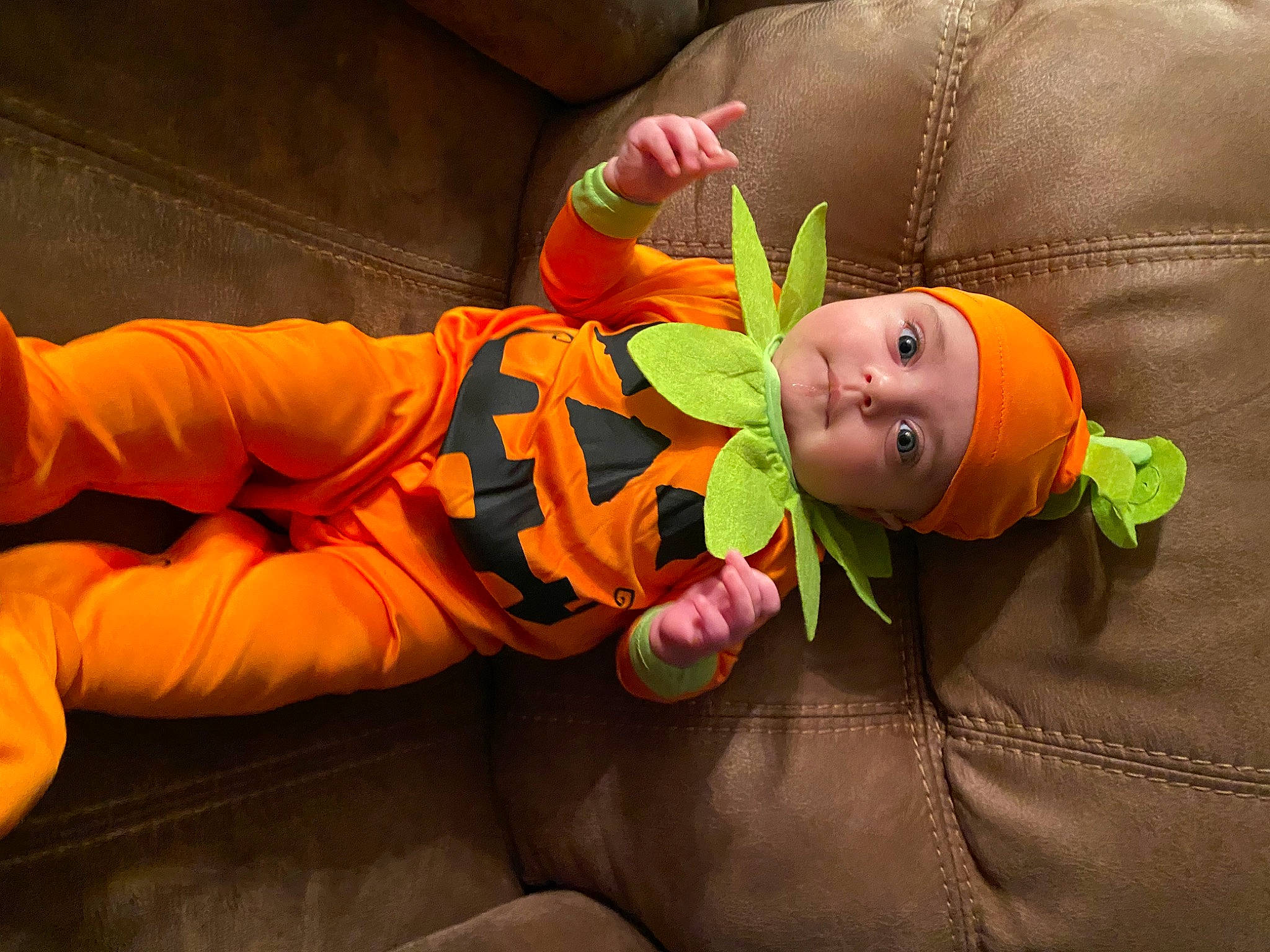Carmen is registered to the contest to win money with this photo: baby, baby_toddler_clothing, bean_bag, bean_bag_chair, child, comfort, costume_hat, fun, glove, happy, hat, headwear, lap, orange, person, personal_protective_equipment, polar_fleece, pumpkin, room, toddler