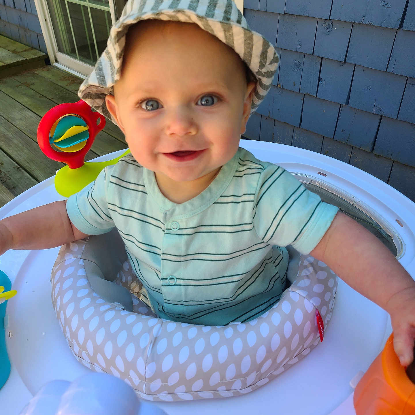 Jacob is registered to the contest to win money with this photo: baby, bodypart, bonnet, cap, clothing, face, finger, food, hand, happy, hat, head, person, photography, portrait, sitting, smile, sunhat, sweets, toy