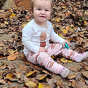 Skylar joined the competition — help win amazing prizes! autumn_leaves, baby, casual, child, cute, daylight, fall, ground, happy, leaf_litter, nature, outdoor, pajamas, person, playful, seasonal, sitting, smiling, toddler, toy