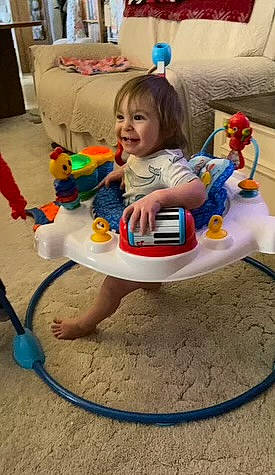 August is registered to the contest to win money with this photo: baby, baby_playing_with_toys, baby_products, baby_toddler_clothing, baby_toys, barefoot, chair, child, fun, happy, joy, person, plastic, play, riding_toy, room, sitting, smile, stuffed_toy, thigh