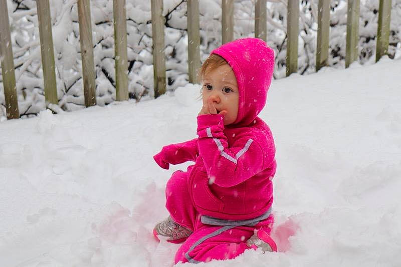 Ember is registered to the contest to win money with this photo: baby, cheek, child, freezing, fun, leisure, magenta, outerwear, person, pink, play, playing_in_the_snow, skin, smile, snow, toddler, winter