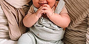 Elodie joined the competition — help win amazing prizes! baby, child, smiling, blue_eyes, hands, sitting, pillows, blanket, cozy, cute, infant, soft_texture, clothing, indoors, portrait, happy, skin, face, couch, relaxing