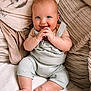 baby, child, smiling, blue_eyes, hands, sitting, pillows, blanket, cozy, cute, infant, soft_texture, clothing, indoors, portrait, happy, skin, face, couch, relaxing