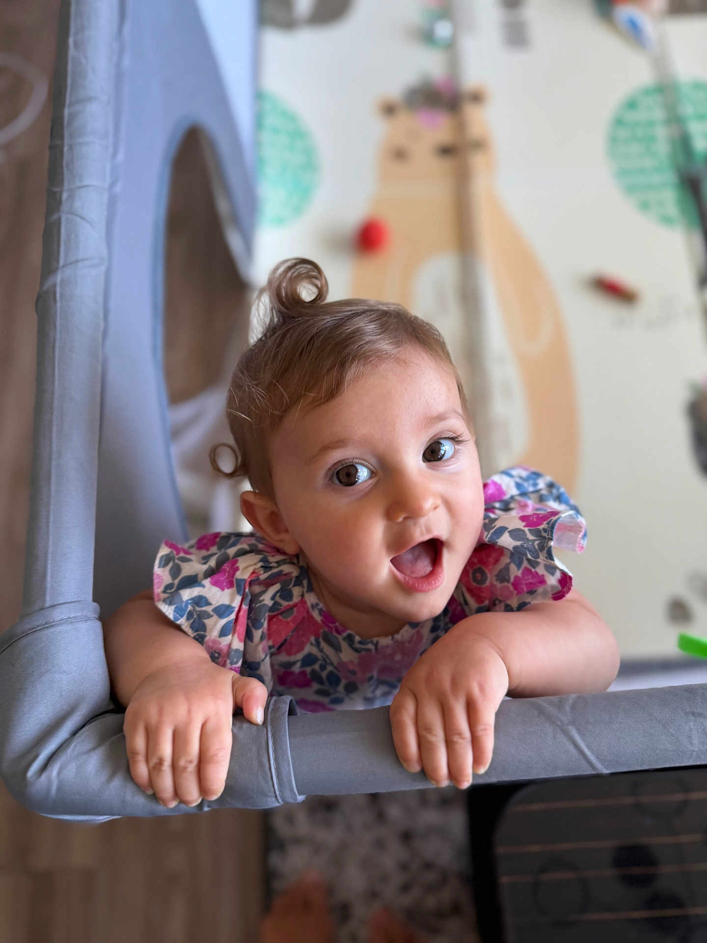 Ghevorchean Suzanna is registered to the contest to win money with this photo: baby, child, cute, smiling, playing, curly_hair, floral_dress, indoors, nursery, toy, hand, face, expression, grip, person, portrait, bright, happy, infant, colorful