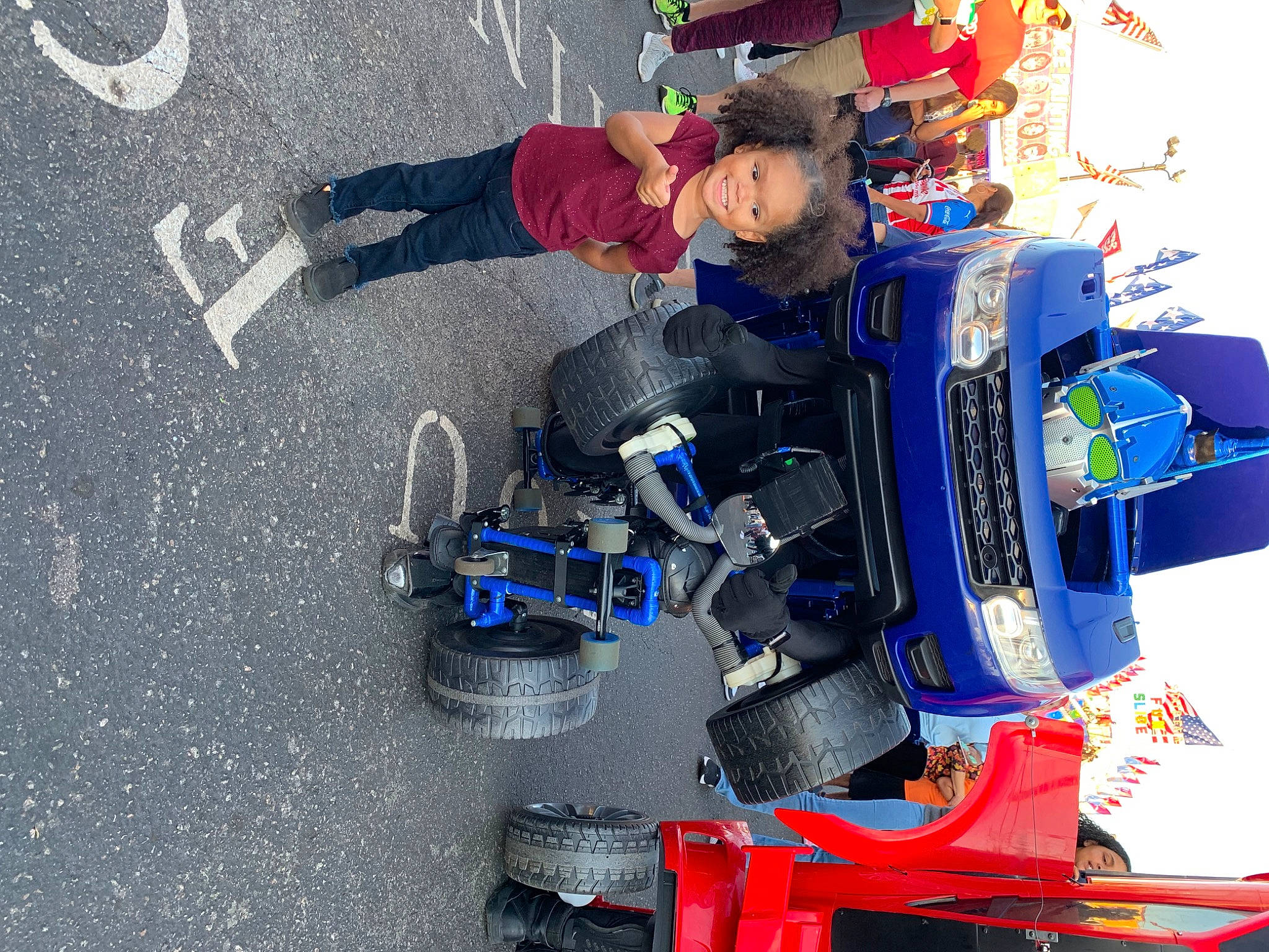 Ryan is registered to the contest to win money with this photo: asphalt, auto_part, automotive_design, automotive_exterior, automotive_tire, electric_blue, engineering, fictional_character, joy, machine, motor_vehicle, person, racing, recreation, rim, space, suspension, tar, tire, toy_vehicle