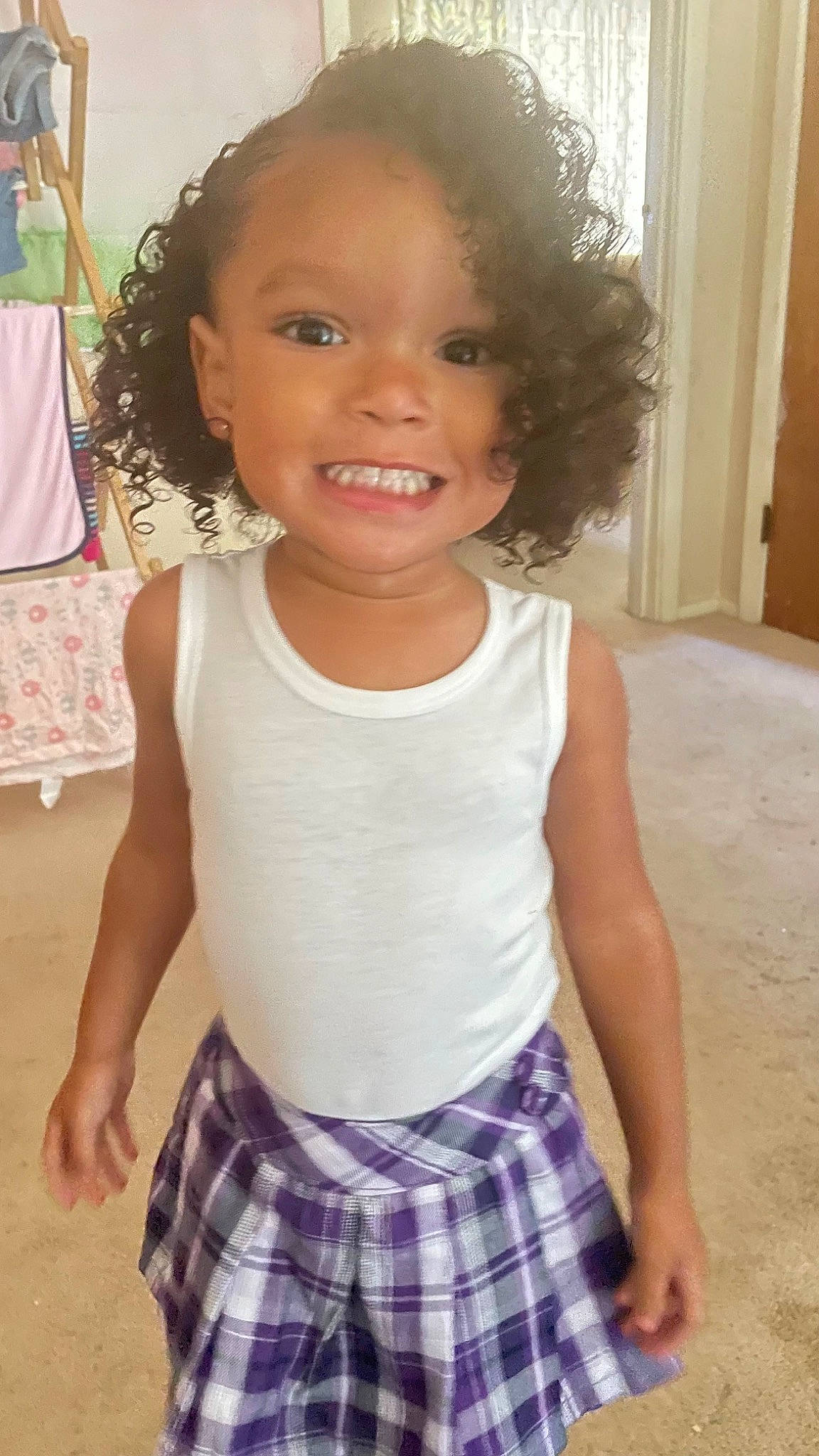 Ryan is registered to the contest to win money with this photo: baby_toddler_clothing, cheek, eye, face, hair, hairstyle, happy, head, joy, neck, organ, person, plaid, shoulder, sleeve, sleeveless_shirt, smile, standing, tartan, toddler