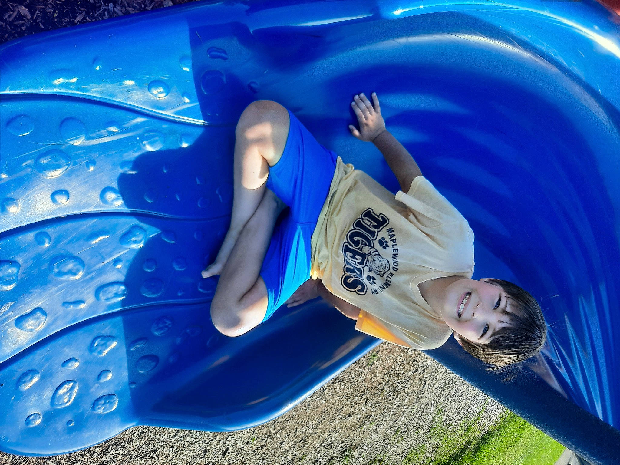 Brayden is registered to the contest to win money with this photo: auto_part, automotive_design, automotive_exterior, automotive_wheel_system, azure, blue, bumper, electric_blue, fun, grass, hood, joy, leisure, person, personal_protective_equipment, plant, plastic, recreation, tree, vehicle_door