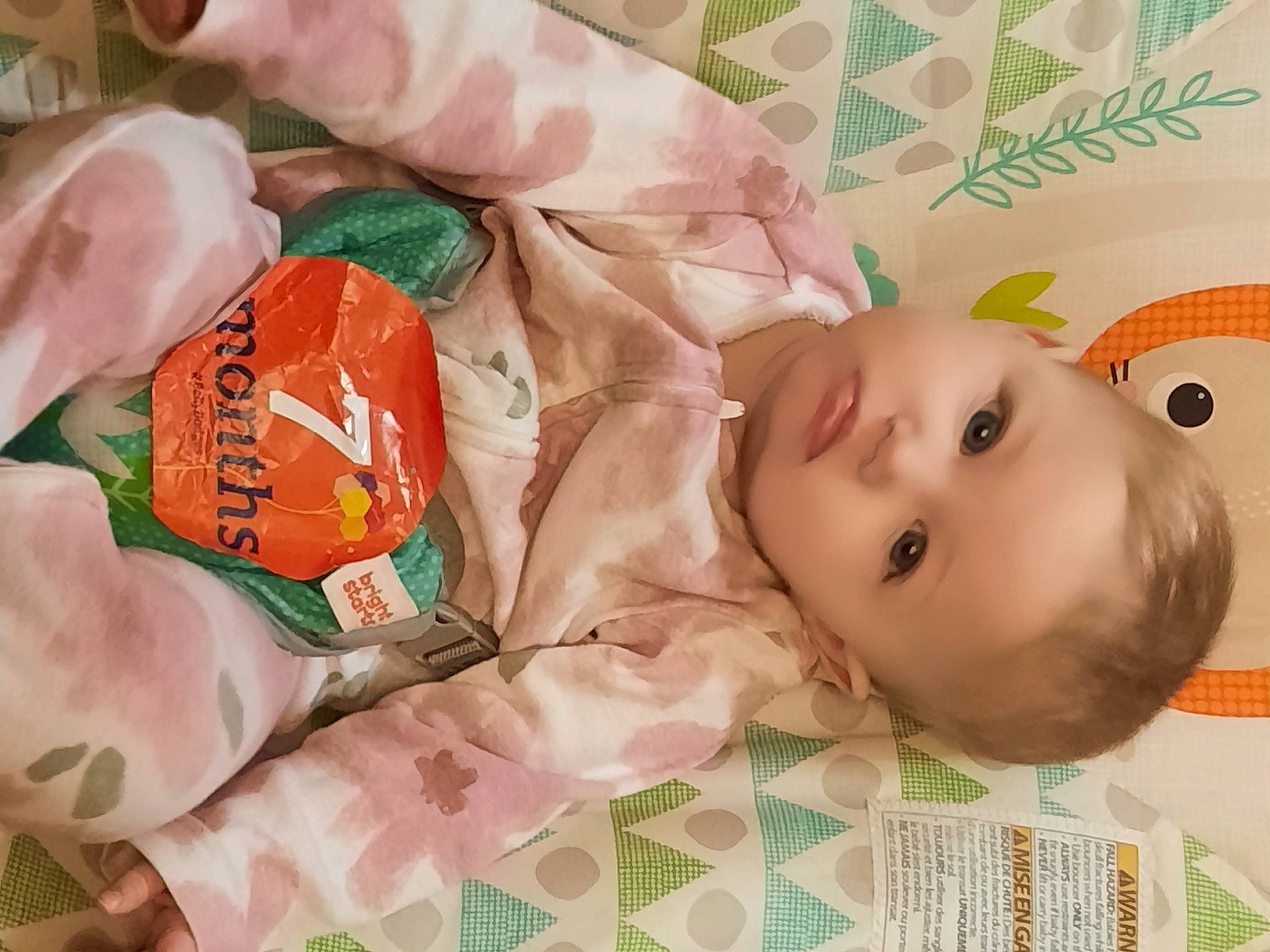 Hazel is registered to the contest to win money with this photo: baby, baby_products, baby_safety, baby_toddler_clothing, child, eyelash, happy, packing_materials, pattern, person, plastic_wrap, skin, textile, toddler