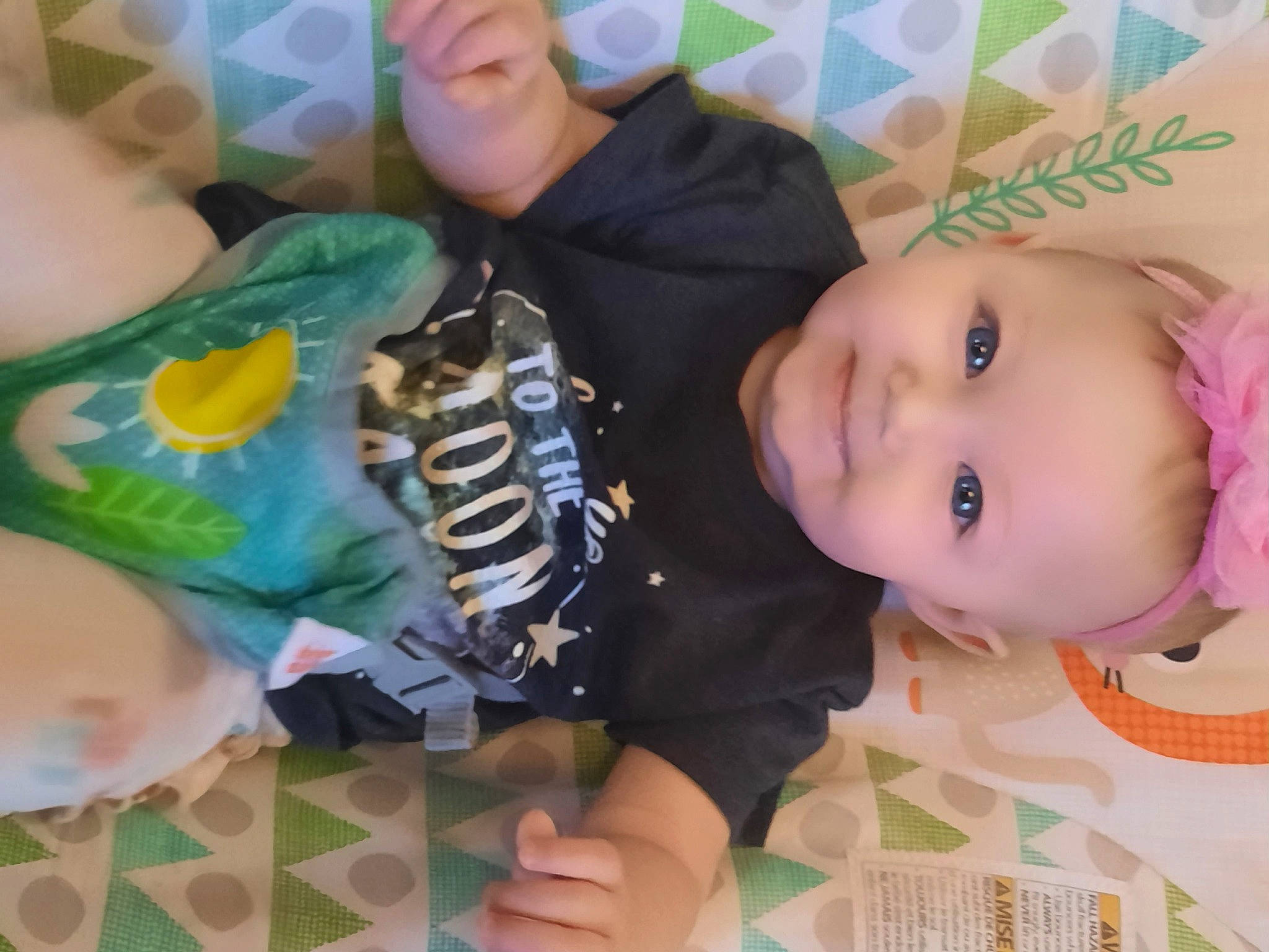 Hazel is registered to the contest to win money with this photo: baby, baby_toddler_clothing, cheek, child, eyelash, fashion_accessory, finger, green, happy, hat, nail, pattern, person, play, room, skin, sleeve, smile, thumb, toddler