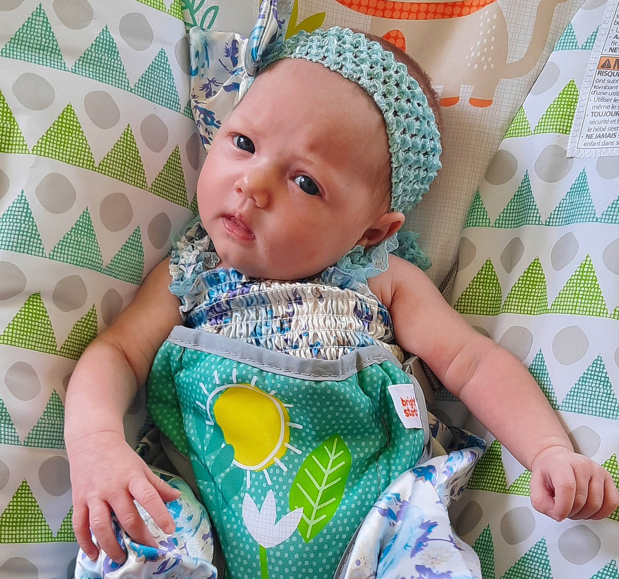 Hazel is registered to the contest to win money with this photo: baby, baby_products, baby_safety, baby_sleeping, baby_toddler_clothing, bib, cheek, child, comfort, green, happy, knit_cap, linens, pattern, person, product, sitting, skin, sleeve, t_shirt