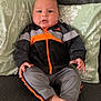 Mateo joined the competition — help win amazing prizes! baby, bodypart, clothing, coat, couch, cushion, face, finger, furniture, hand, head, homedecor, jacket, pants, person, photography, pillow, portrait, sitting, sleeping