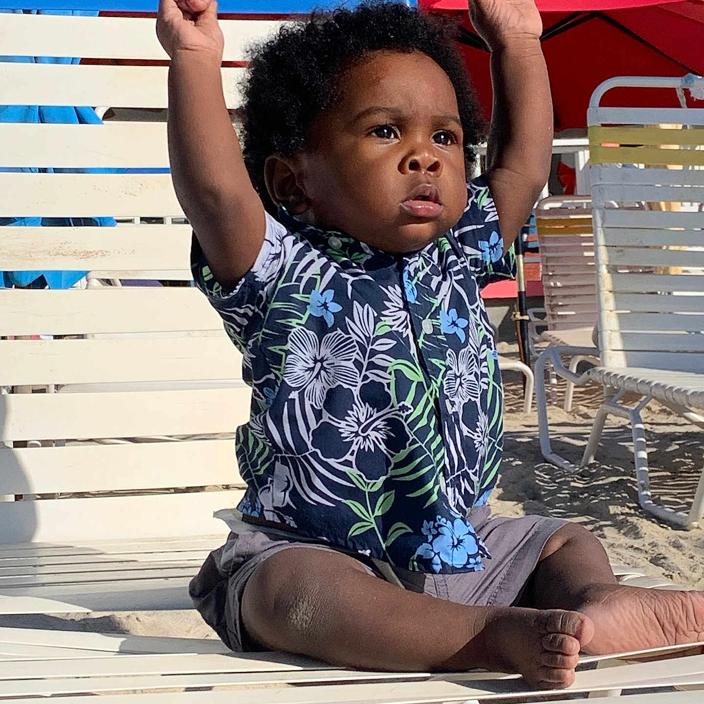 O'Korie is registered to the contest to win money with this photo: architecture, baby, beachwear, bodypart, building, clothing, face, finger, furniture, hand, head, outdoors, person, photography, portrait, shorts, sitting, sleeve, summer, t_shirt