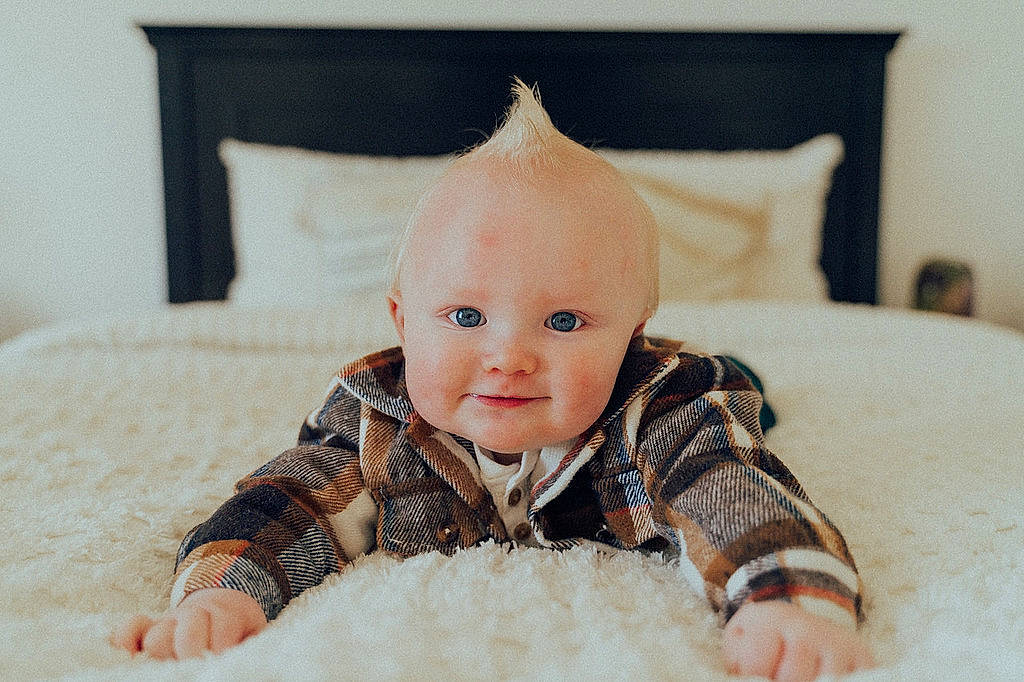 Beckham is registered to the contest to win money with this photo: baby, baby_toddler_clothing, beanie, cheek, child, comfort, eye, fashion_accessory, floor, flooring, fur, happy, head, linens, person, sitting, skin, sleeve, smile, toddler