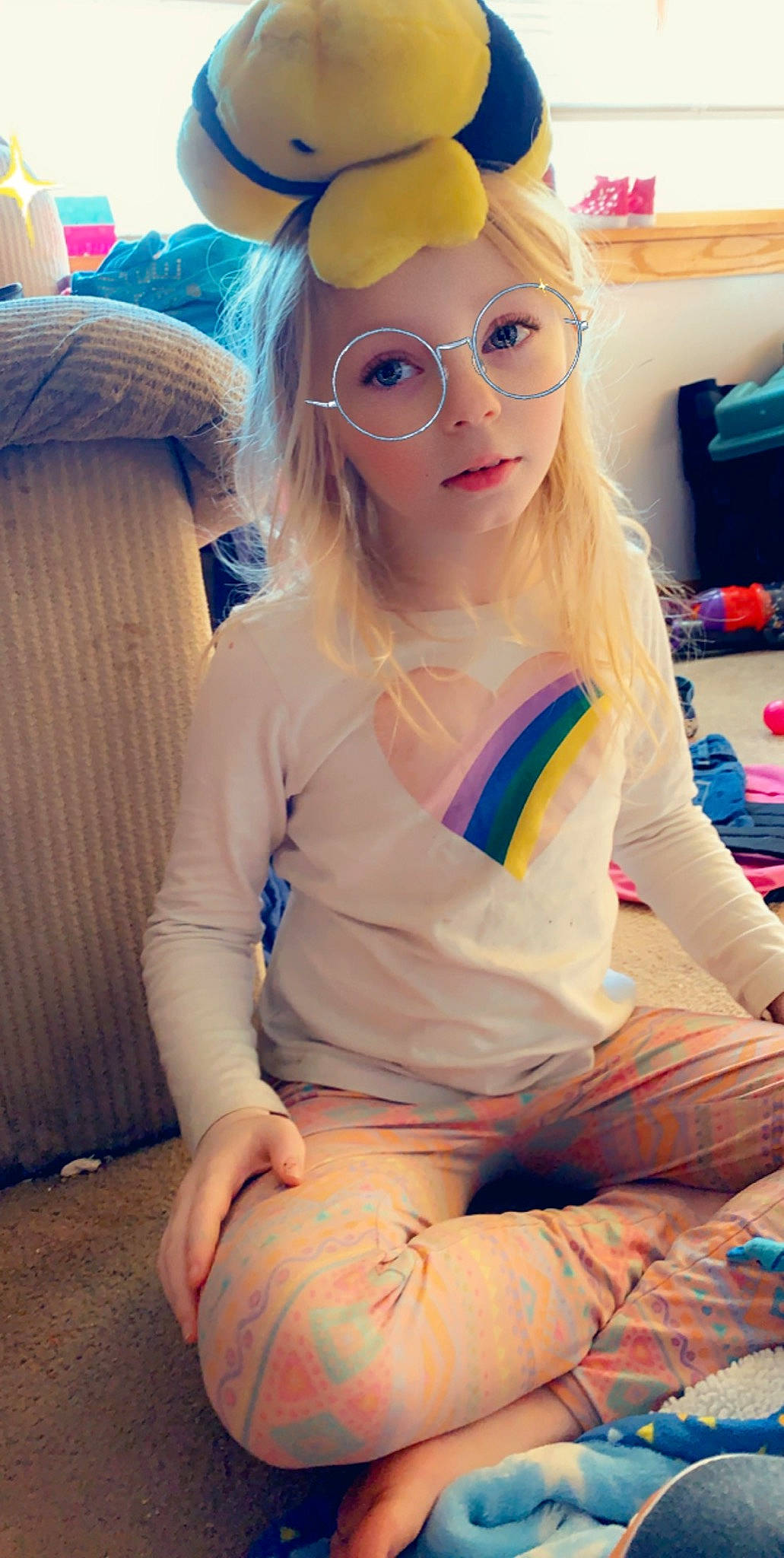 Aubry is registered to the contest to win money with this photo: costume_accessory, costume_hat, mouth, nose, party_supply, person, sitting, sweater