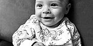 Carter is registered to the contest to win money with this photo: baby, babylaughing, bodypart, clothing, couch, dress, face, finger, furniture, hand, happy, head, laughing, newborn, person, photography, portrait, sitting, skin, smile