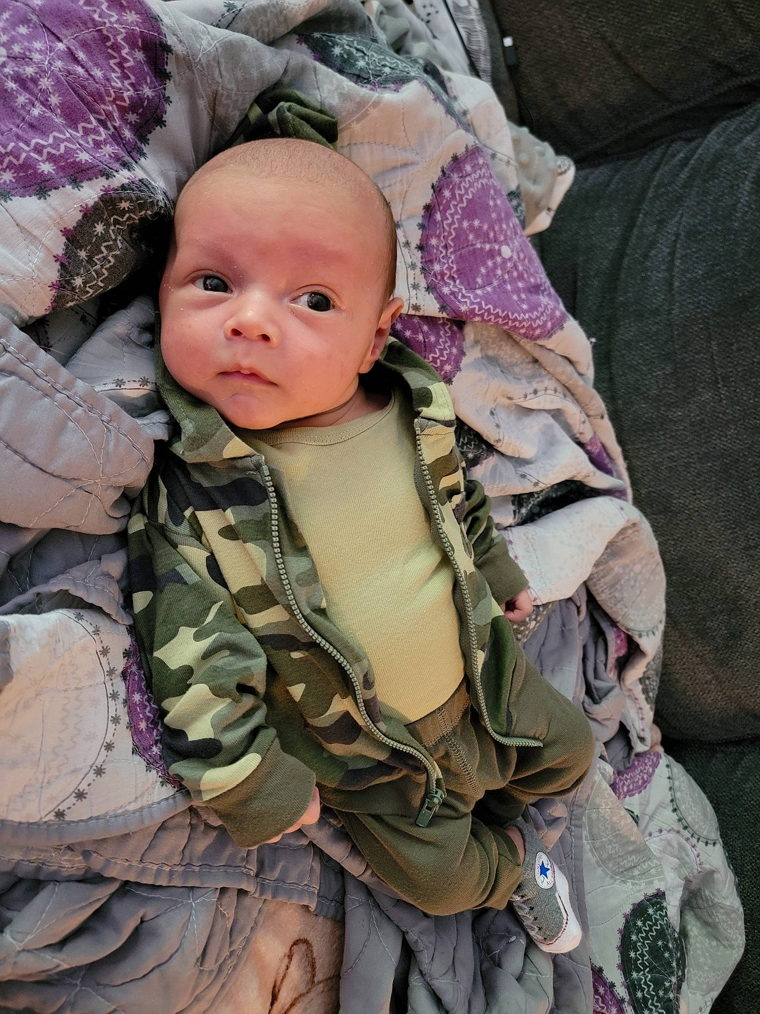 Liam is registered to the contest to win money with this photo: baby, baby_products, baby_toddler_clothing, camouflage, cheek, child, comfort, fashion_accessory, fur, linens, military, military_camouflage, military_person, military_uniform, outerwear, pattern, person, skin, sleeve, toddler