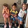 Aneria joined the competition — help win amazing prizes! child, children, door, carpet, indoor, footwear, sandals, shorts, tshirt, dress, water_bottle, standing, hair_bun, pigtails, smiling, cute, kids, playful, happy, portrait