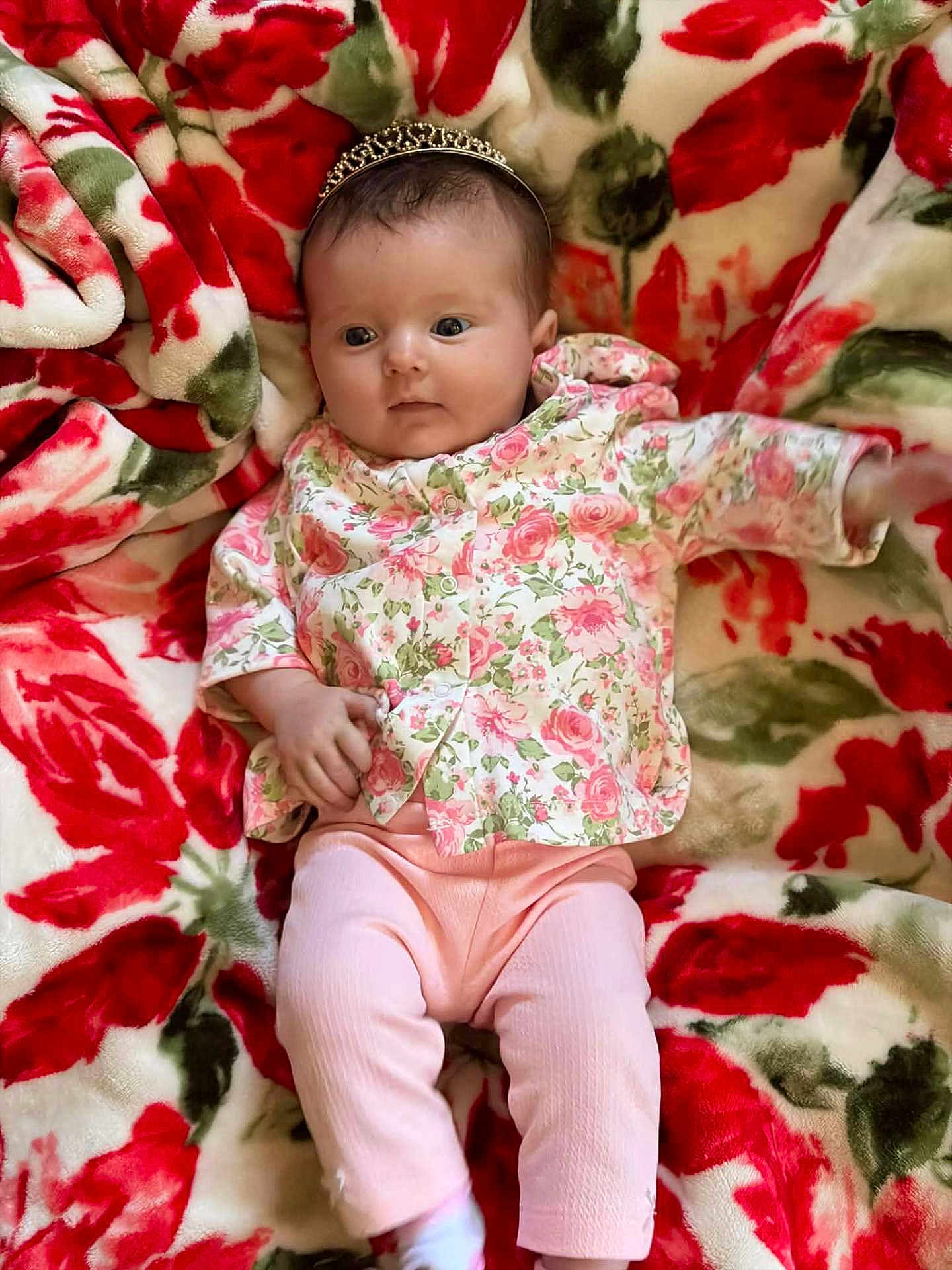 Shelbi joined the competition — help win amazing prizes! baby, infant, child, headband, tiara, floral_blanket, blanket, floral_top, pink_pants, newborn, portrait, lying_down, cute, eyes_open, hand, legs, skin, cozy, pattern, indoor