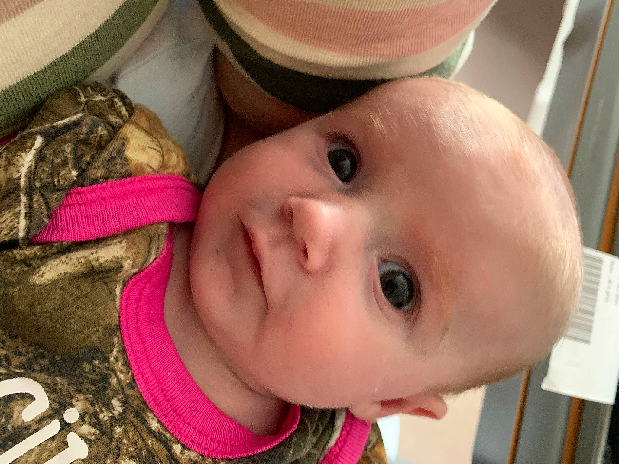 Brynnlee is registered to the contest to win money with this photo: baby, cap, cheek, child, chin, close_up, ear, eye, face, fashion_accessory, hat, head, headgear, lip, mouth, nose, person, pink, skin, smile
