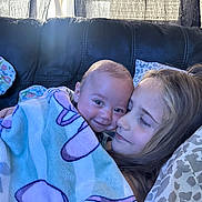 Miles joined the competition — help win amazing prizes! baby, child, couch, blanket, smile, happy, face, girl, indoor, leather, pillow, curtain, cozy, family, portrait, closeup, toddler, comfort, cuddle, relaxation
