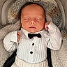 baby, sleeping, infant, tuxedo, bowtie, white_clothing, blanket, plush, cozy, cute, newborn, soft, portrait, resting, child, indoors, fashion, adorable, peaceful, cuddle