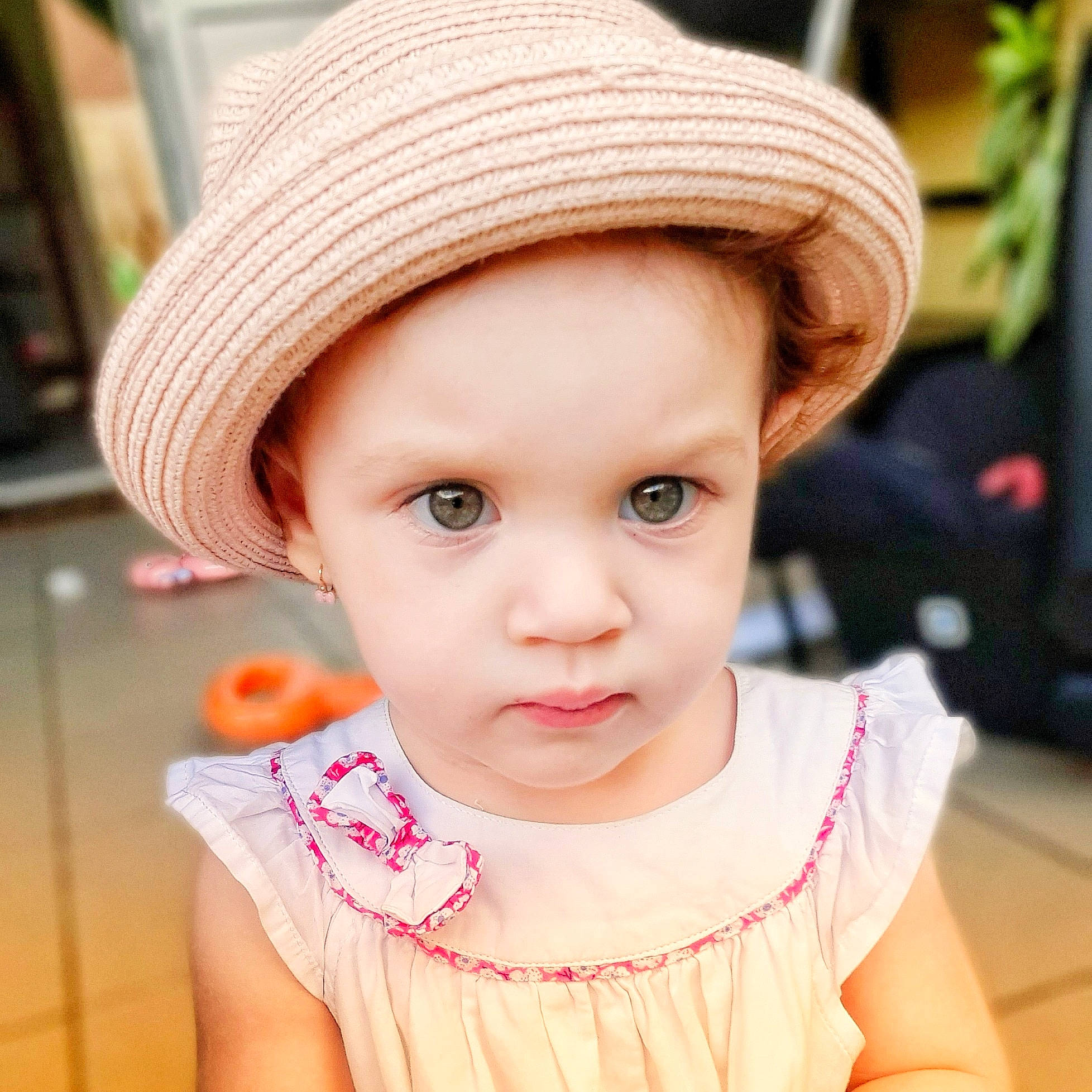 Elyna a rejoint le concours — aidez-le/la à gagner de superbes lots ! baby_toddler_clothing, cheek, child, child_model, clothing, costume_accessory, day_dress, embellishment, eyelash, fedora, hat, headgear, headwear, lip, mouth, nose, person, pink, shelf, skin