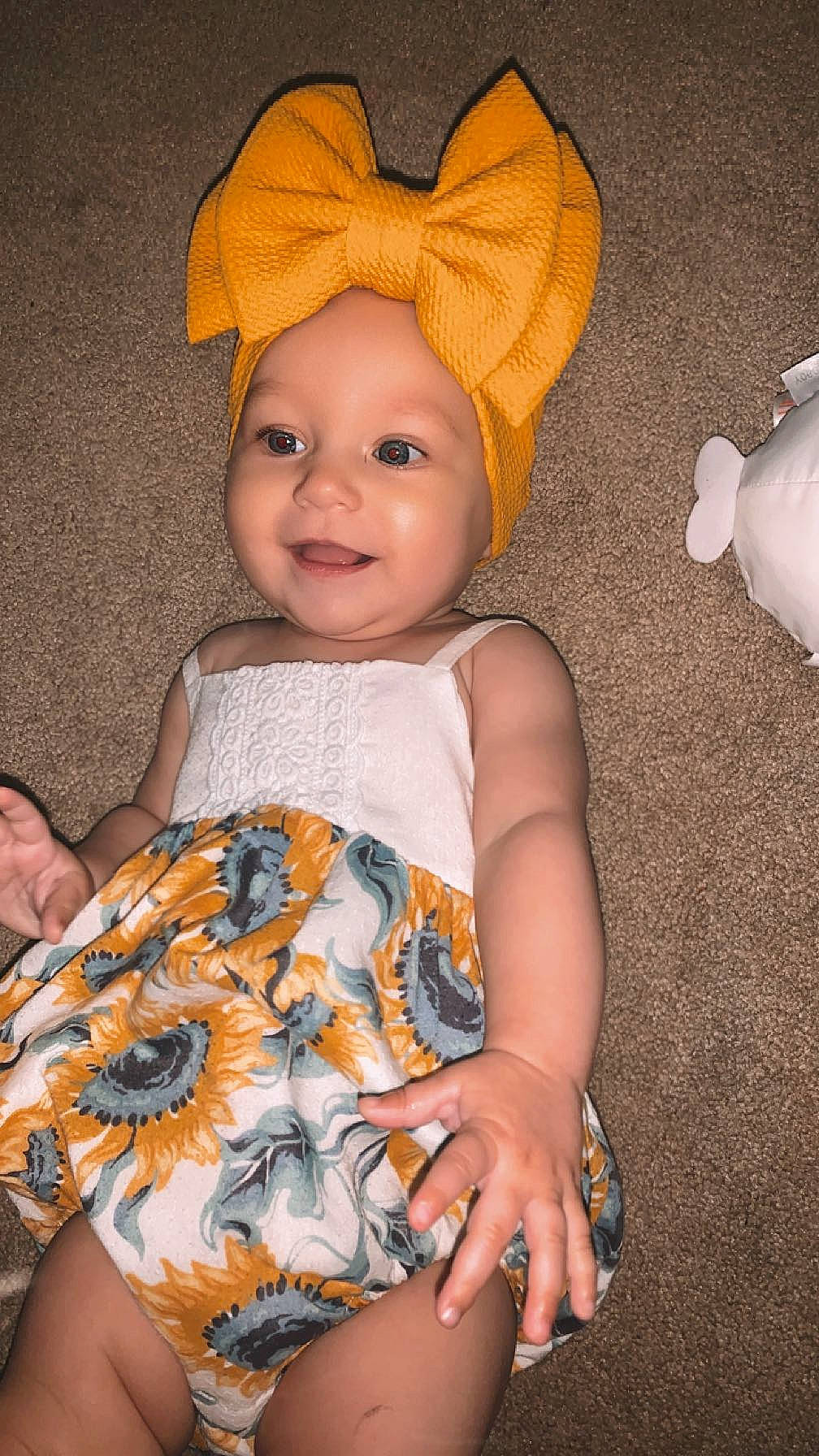 Kyla is registered to the contest to win money with this photo: baby, baby_toddler_clothing, cap, child, chin, costume_hat, dress, eye, face, fun, happy, head, headwear, human_body, iris, joy, pattern, person, skin, sleeve