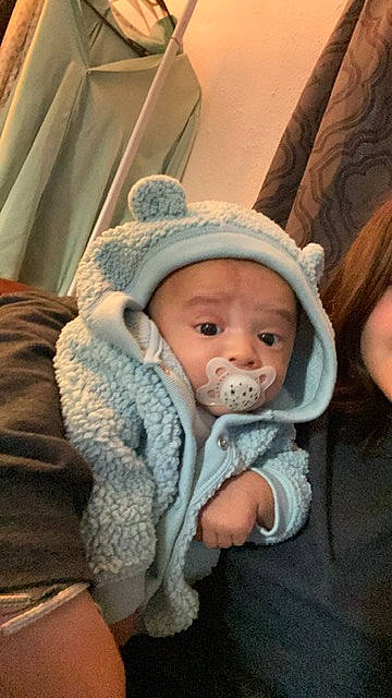 Antonio is registered to the contest to win money with this photo: baby, baby_products, baby_toddler_clothing, cap, cheek, child, comfort, eye, fur, hat, headgear, headwear, iris, mouth, nose, person, sitting, skin, sleeve, toddler