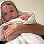 David is registered to the contest to win money with this photo: baby, child, close_up, cuddly, curious, cute, expression, face, hands, holding, indoor, infant, newborn, person, portrait, skin, soft, towel, wet_hair, white