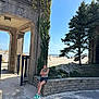 David joined the competition — help win amazing prizes! child, baby, person, beach, sand, stone_wall, ivy, tree, sky, ocean, arch, gate, sunlight, shadow, outdoor, nature, casual_clothing, green_shoes, relaxation, holding