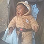 baby, child, stroller, blanket, fur_clothing, hooded, outdoor, happy, infant, safety_belt, cute, smiling, person, young_child, warm_clothing, toddler, seat, baby_clothes, plush, protective