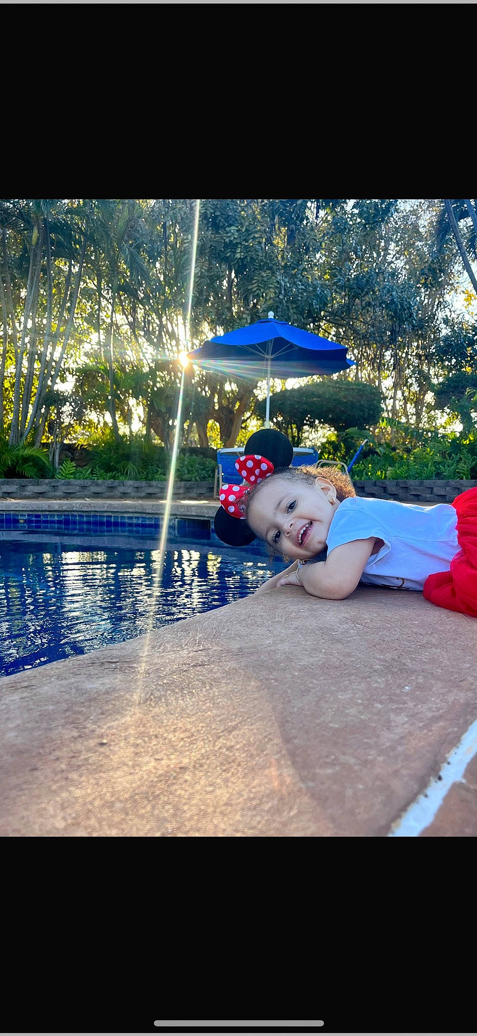 Leiyanni is registered to the contest to win money with this photo: asphalt, child, cool, electric_blue, flash_photography, fun, grass, happy, joy, landscape, leisure, person, plant, recreation, swimming_pool, tints_and_shades, toddler, travel, tree, umbrella