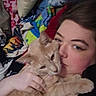 Emerald joined the competition — help win amazing prizes! person, cat, orange_tabby, blanket, indoor, cuddle, face, bed, comfort, snuggle, pet, animal, fur, cozy, rest, clothing, hand, eyebrow, eyelid, home