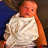 Peter is registered to the contest to win money with this photo: baby, swaddle, blanket, bear_pattern, adult_arm, blue_shirt, watch, indoor, portrait, person, child, newborn, comfort, holding, resting, clothing, human, casual, seated, toddler
