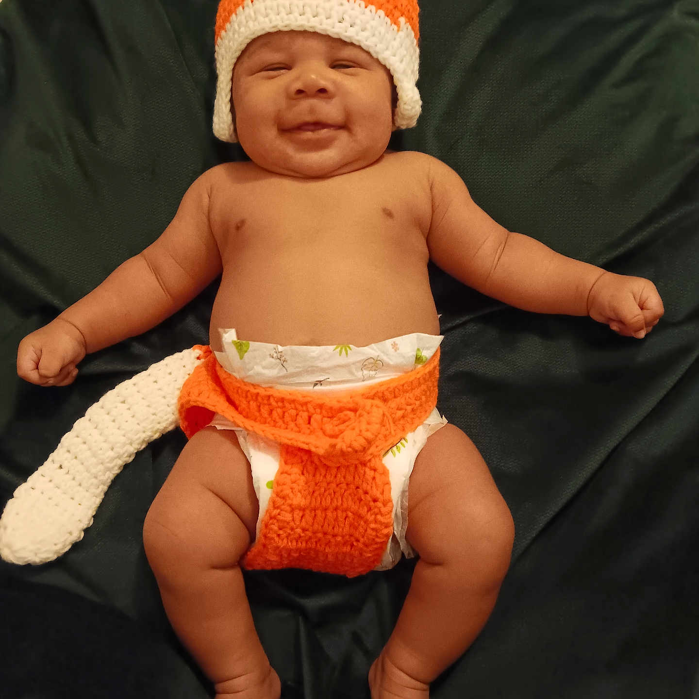 Kevontey participe au concours pour gagner de l'argent avec cette photo : baby, beanie, bodypart, bonnet, cap, clothing, couch, diaper, face, finger, furniture, glove, hand, hat, head, newborn, person, photography, portrait, sitting