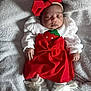 baby, child, closeup, cozy, cute, feet, hands, headband, indoors, infant, newborn, pajamas, portrait, red_bow, red_dress, resting, sleeping, soft_texture, white_blanket, white_socks