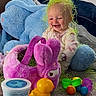 Haizley is registered to the contest to win money with this photo: baby, child, toys, plush_bunny, rubber_duck, colorful, floor, carpet, stuffed_animal, green_grass, smiling, indoors, playtime, happy, cute, purple, yellow, blue, clothing, person