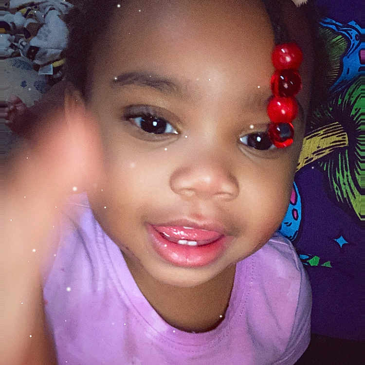 Patience is registered to the contest to win money with this photo: accessories, baby, bodypart, clothing, cosmetics, earring, face, finger, hand, happy, hat, head, jewelry, lipstick, mouth, person, photography, portrait, smile, t_shirt