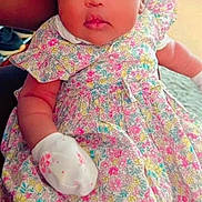 Akeno is registered to the contest to win money with this photo: baby, child, infant, floral_dress, mittens, curly_hair, indoor, sneakers, colorful, cute, portrait, person, young, skin, face, eyes, expression, sitting, soft_lighting, cozy