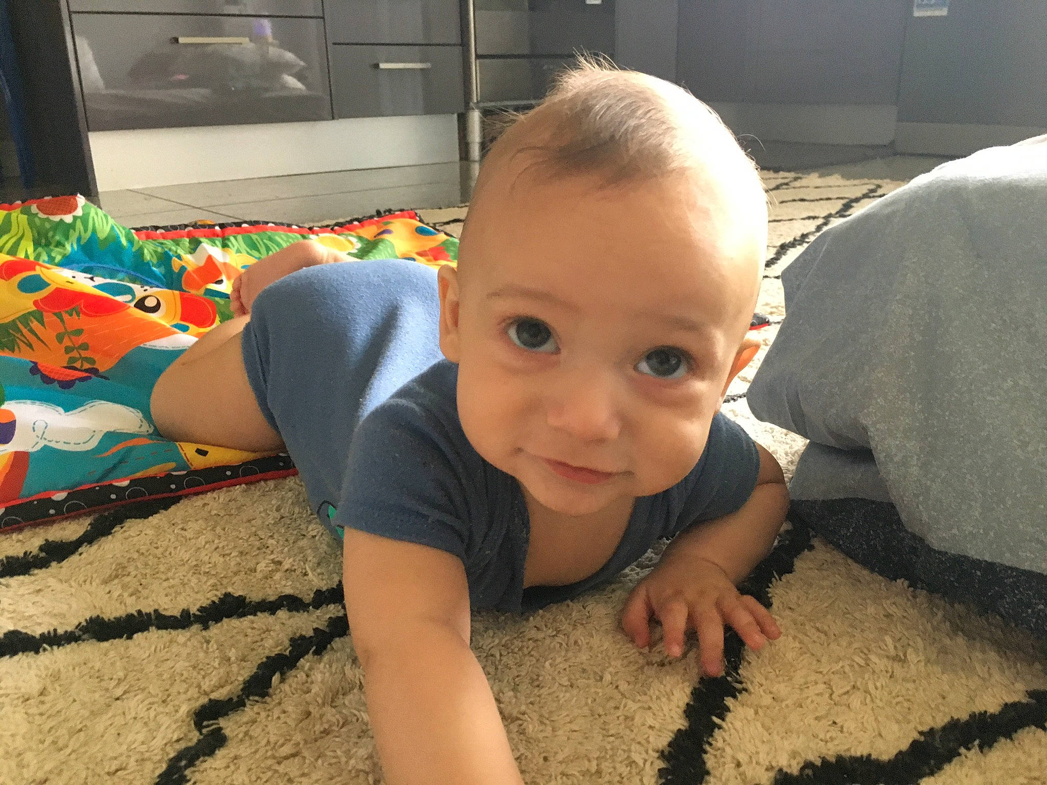 Jaiden is registered to the contest to win money with this photo: baby, cheek, chest, child, comfort, crawling, floor, flooring, fun, happy, head, joint, mouth, person, skin, smile, thigh, thumb, toddler, tummy_time